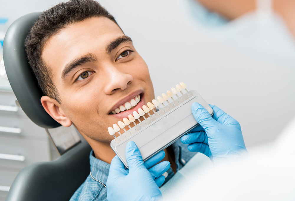 Patient looking at his prosthodontics options at a dental office. 