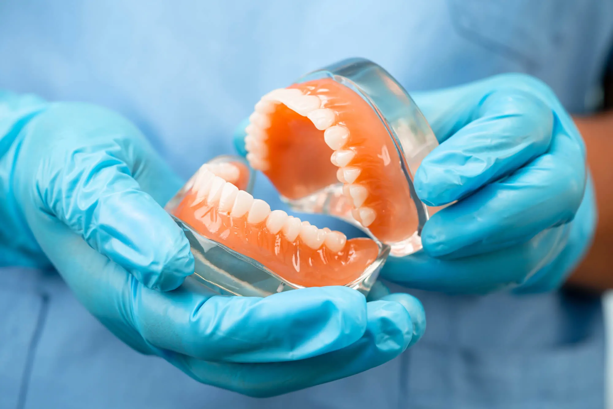 dentist-holding-a-full-set-of-dentures-boca-raton