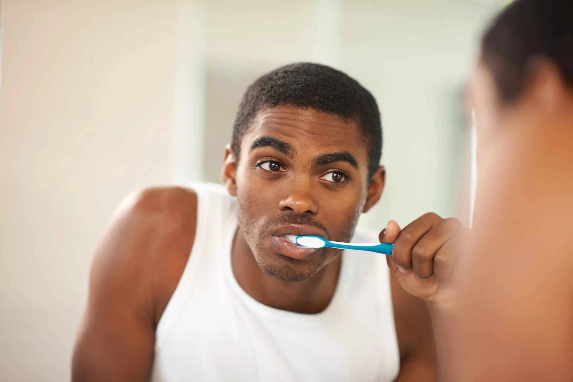 man brushing teeth as recommended by his Dentist in East Boca Raton